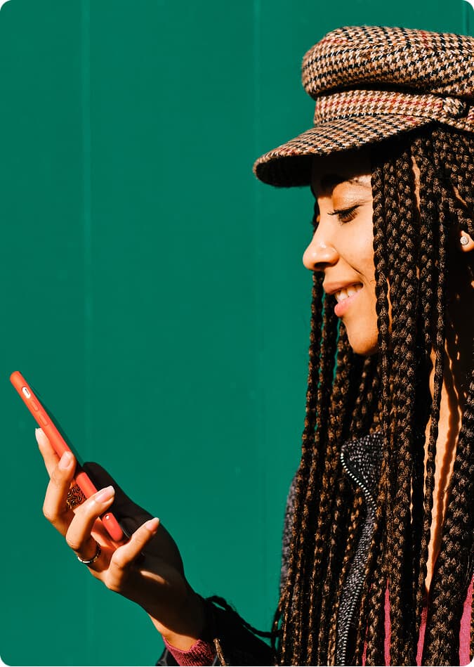 Woman wearing a hat using her phone